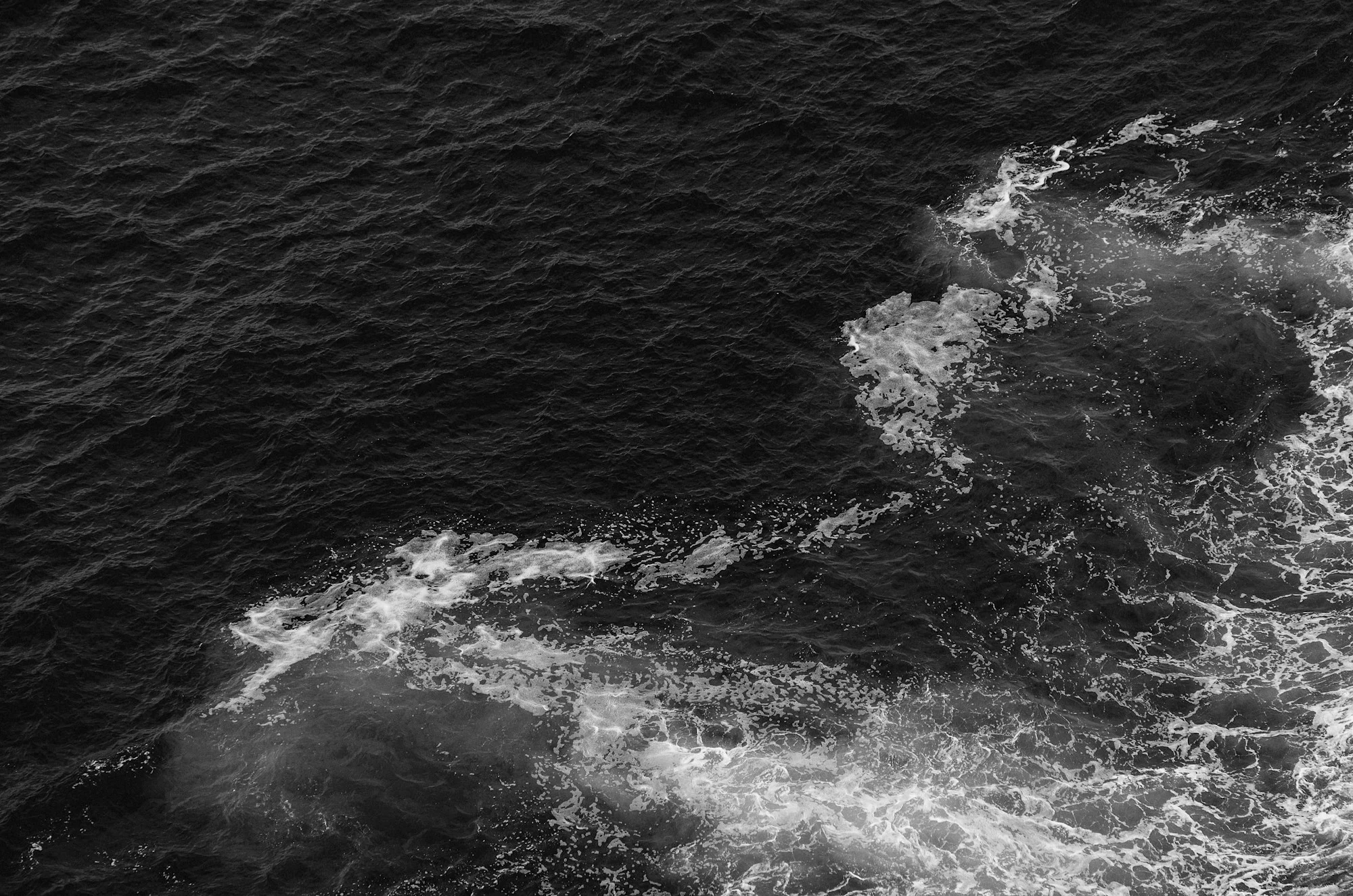 Dark ocean waves with white foam